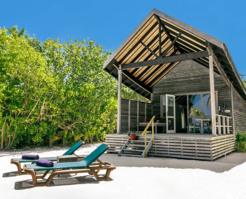 KUR_Deluxe_Beach_Villa_2025_02 The deluxe beach villa bedroom at Kuredu island resort & spa in The Maldives